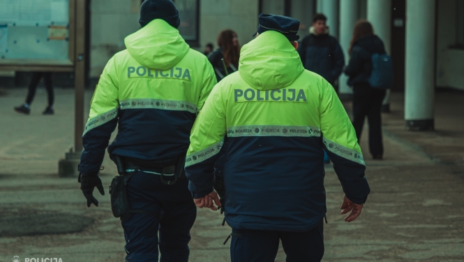 divi policisti formastērpā ar mugurpusi