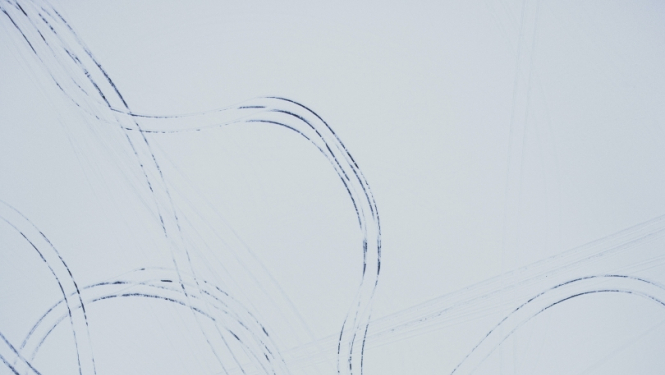 Automašīnu riepu nospiedumi sniegā