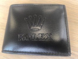 melns maks ar kroni un uzrakstu rolex