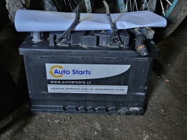 akumulatora baterija auto starts melnā krāsā uz betona grīdas