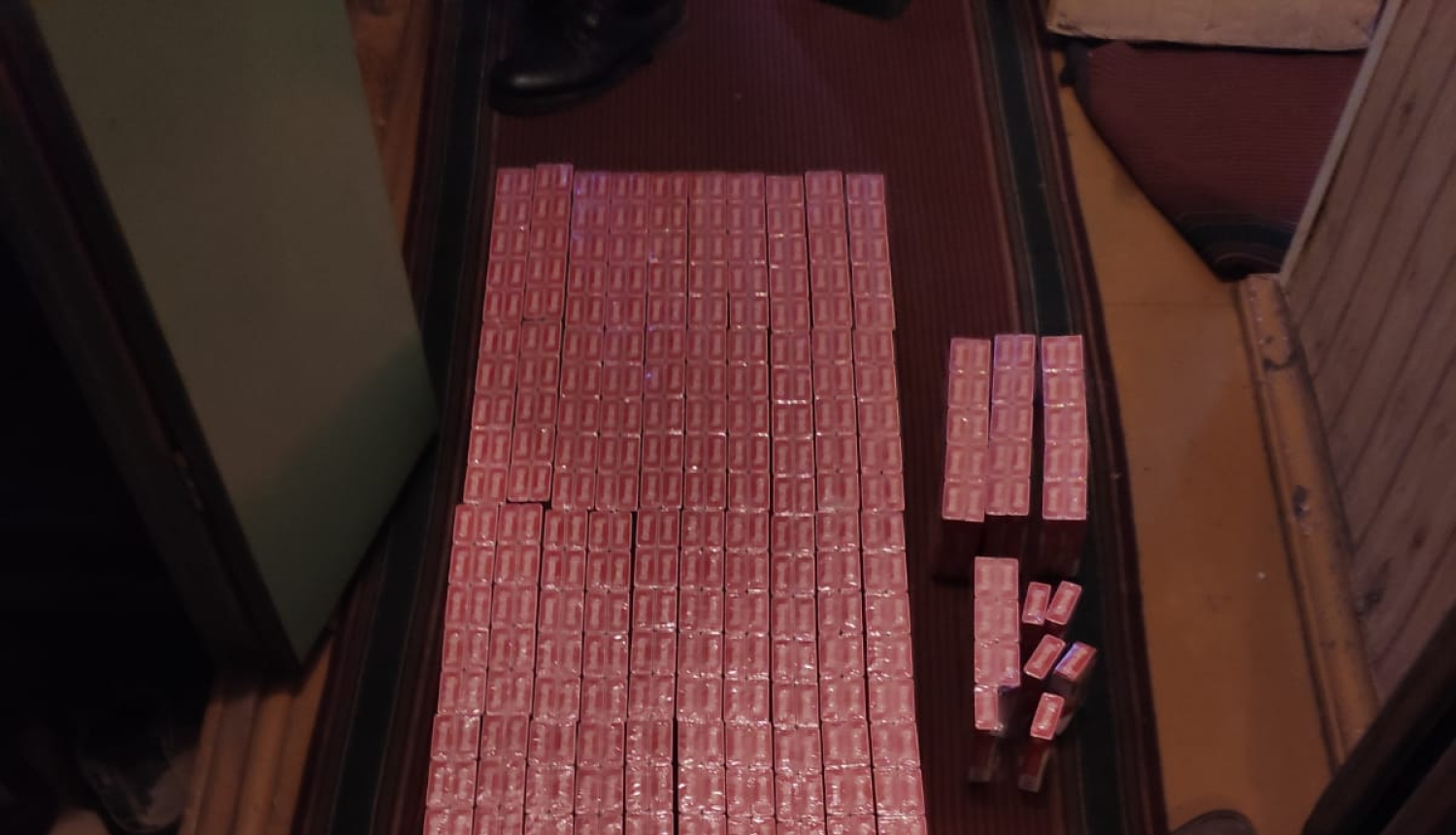 Uz grīdas saliktas sarkanas cigarešu paciņas